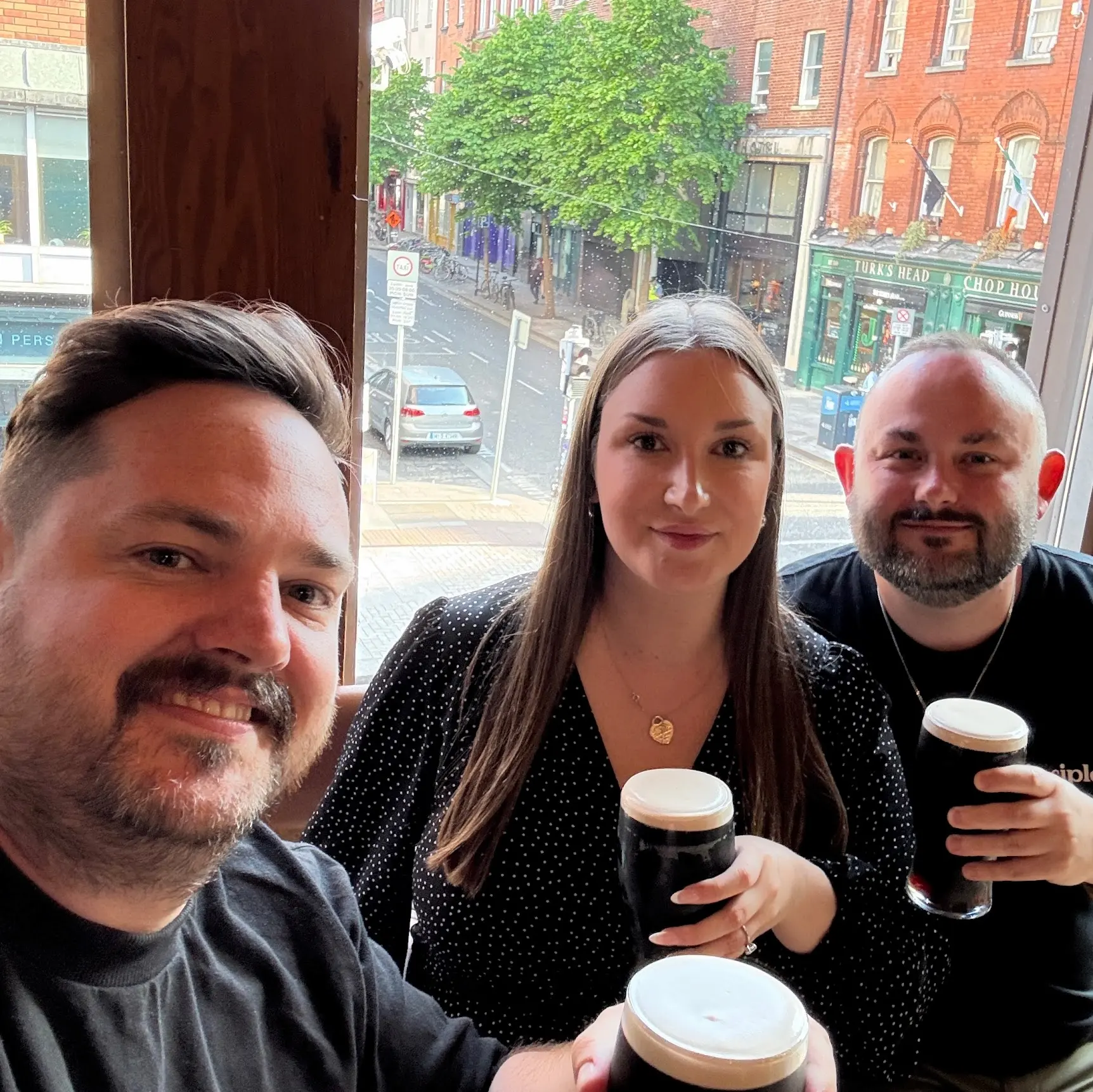 two guests enjoying stout with tour guide marty